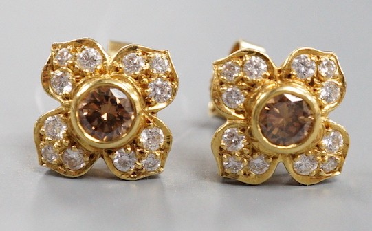 A modern pair of 750 yellow metal and two colour diamond cluster set earrings, 9mm, gross weight 4.1 grams, the central stone of a champagne/brown colour.